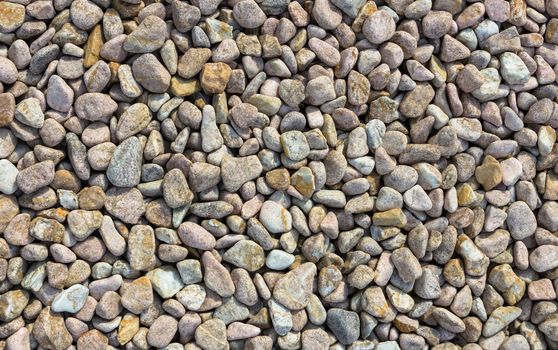 Abstract small stone background, texture stone. Pile of pastel colored stones.