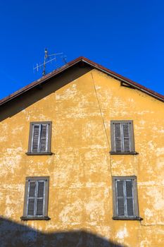 The facade of an old house with peeling plaster.