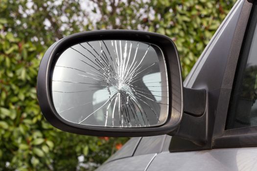 Closeup of damaged rearview mirror.
