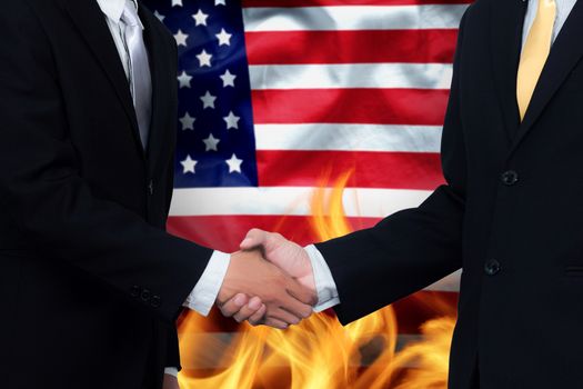 trade agreements and business practices in the United States concept. hand of businessman shaking on America flag background and fire