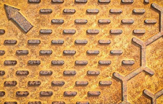 Steel rusty texture from Manhole cover. Orange metallic background. Detail of Manhole cover pattern.