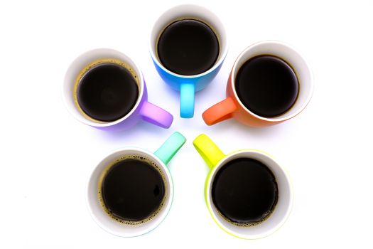 group of colorful coffee mugs with black coffee, isolated on white background