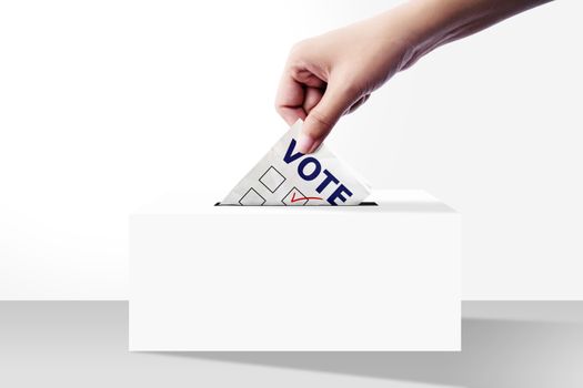 close up of hand holding voting paper for election vote into the ballot box on white background