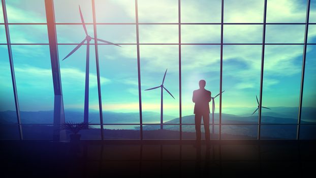 A silhouette of a businessman is standing against an office window overlooking the wind farms.