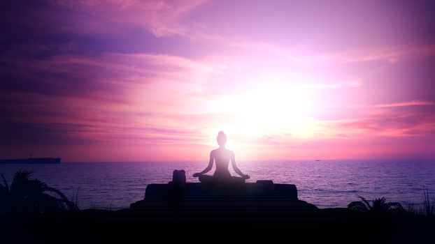 Silhouette of a woman meditating against a sunset in the ocean.