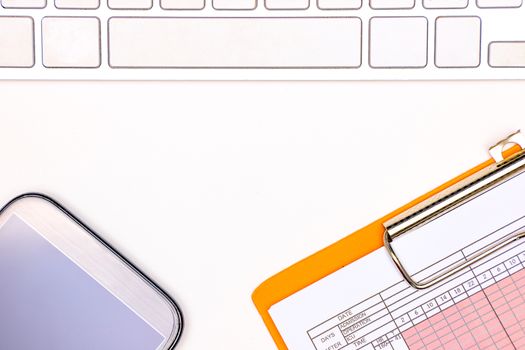 a computer keyboard, a patient vital sign chart, and a smartphone on a white table background, doctor working space concept