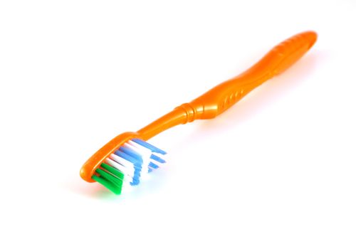 Orange toothbrush over white