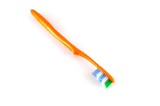 Orange toothbrush over white