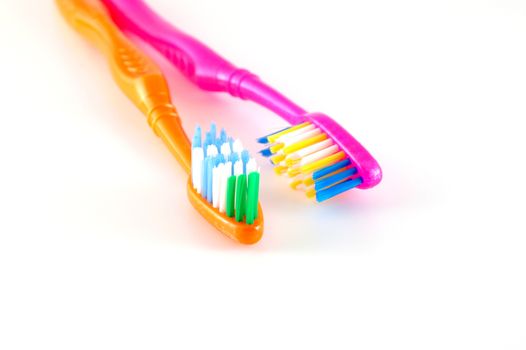 Two tooth-brushes over white