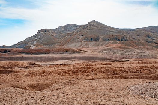 View of  the Valley of the Kings in Egypt, with a soft blue sky over the desert