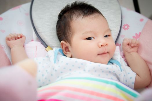 adorable cute Asian baby lay down for sleep on bed at bedtime on a comfortable soft mattress.