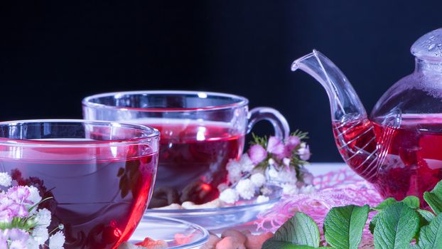 Creative layout made of cup of red tea and leafs. Tea time: cup of tea, carcade, karkade, rooibos. Oriental, cozy, ceremony, tradition, japanese, leafy, hygge, autumn, 5 o'clock, afternoon tea