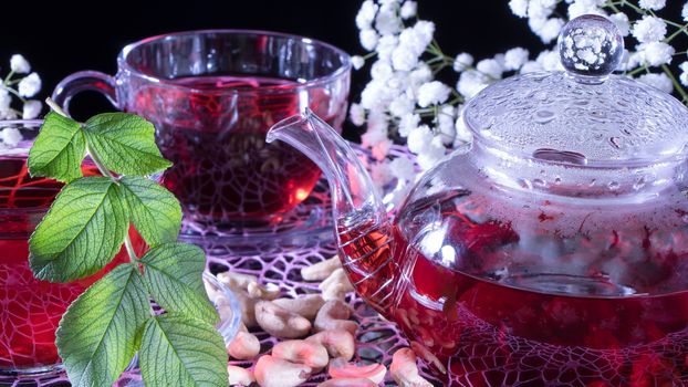 Red hot hibiscus tea in glass mug. Tea time: cup of tea, carcade, karkade, rooibos. Oriental, cozy, ceremony, tradition, japanese, leafy, hygge, autumn, 5 o'clock, afternoon tea