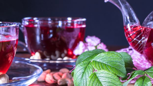 English tea. Red hot hibiscus tea in glass mug. Tea time: cup of tea, carcade, karkade, rooibos. Oriental, cozy, ceremony, tradition, japanese, leafy, hygge, autumn, 5 o'clock, afternoon