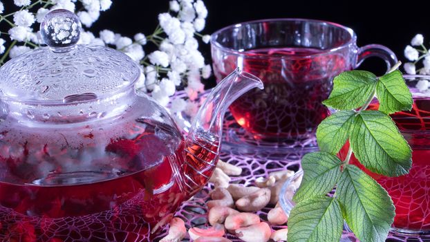 Creative layout made of cup of red tea and leafs. Tea time: cup of tea, carcade, karkade, rooibos. Oriental, cozy, ceremony,tradition,japanese, leafy,hygge,autumn,tea with raspberries,afternoon tea