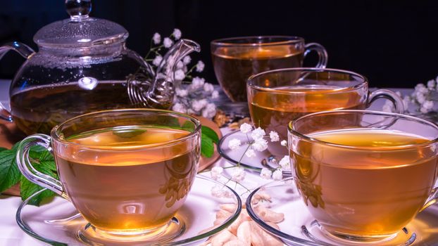 English tea. Red hot hibiscus tea in glass mug. Tea time: cup of tea, carcade, karkade, rooibos. Oriental, cozy, ceremony, tradition, japanese, leafy, hygge, autumn, 5 o'clock, afternoon