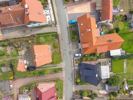 Aerial photo with the drone, a new build-up plot with single houses and gardens, narrow neighborhood