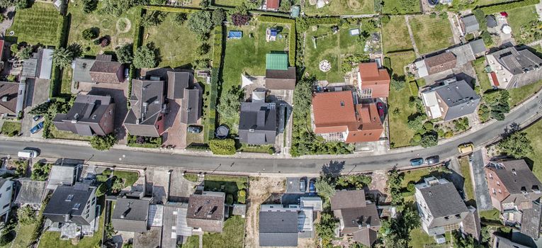 row of houses on a street in Germany, detached houses with gardens and lawns, aerial photo