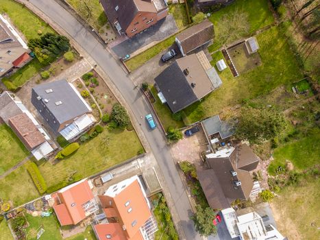 Aerial photo with the drone, a new build-up plot with single houses and gardens, narrow neighborhood