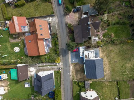 Aerial photo with the drone, a new build-up plot with single houses and gardens, narrow neighborhood