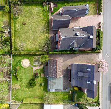 Aerial photo with the drone, a new build-up plot with single houses and gardens, narrow neighborhood