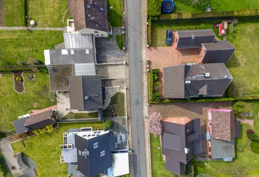 Aerial photo with the drone, a new build-up plot with single houses and gardens, narrow neighborhood