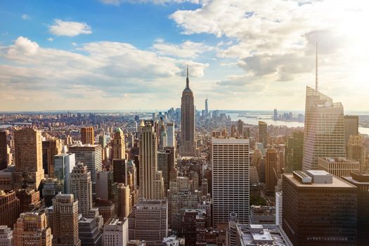 New York City skyline from roof top with urban skyscrapers before sunset. New York, USA. 