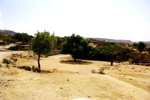 Eritrea, Africa - 08/10/2019: Travelling around the vilages near Asmara and Massawa. An amazing caption of the trees, mountains and some old typical houses with very hot climate in Eritrea.