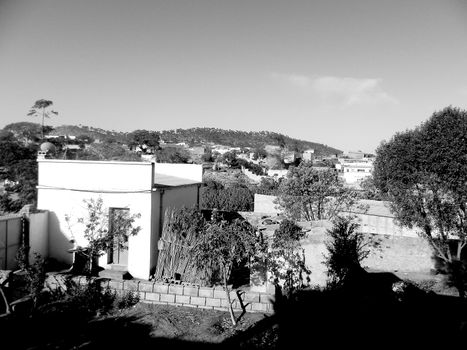 Eritrea, Africa - 08/10/2019: Travelling around the vilages near Asmara and Massawa. An amazing caption of the trees, mountains and some old typical houses with very hot climate in Eritrea.