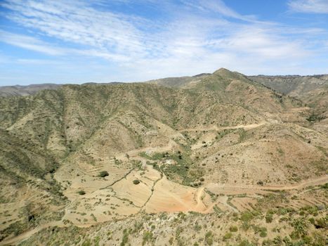 Eritrea, Africa - 08/10/2019: Travelling around the vilages near Asmara and Massawa. An amazing caption of the trees, mountains and some old typical houses with very hot climate in Eritrea.