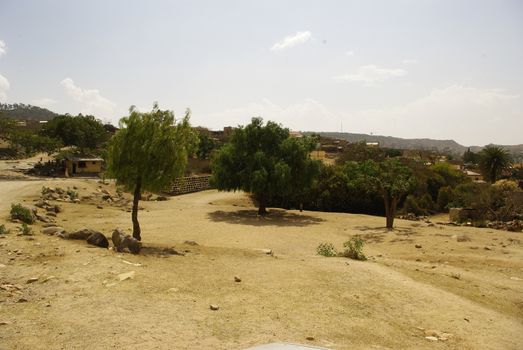 Eritrea, Africa - 08/10/2019: Travelling around the vilages near Asmara and Massawa. An amazing caption of the trees, mountains and some old typical houses with very hot climate in Eritrea.