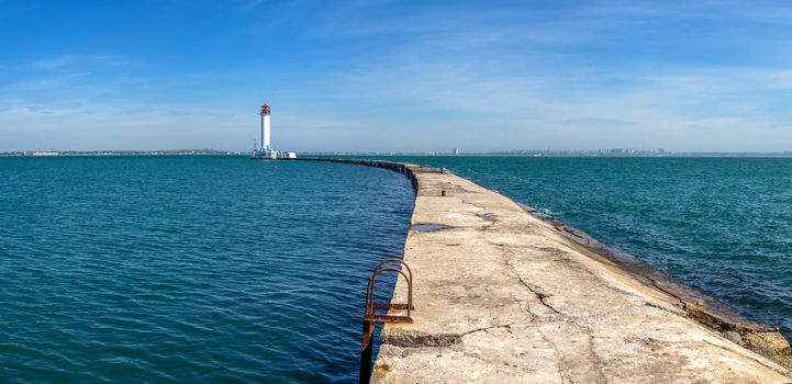 Lighthouse at the entrance to the harbor of Odessa seaport, on a sunny summer day