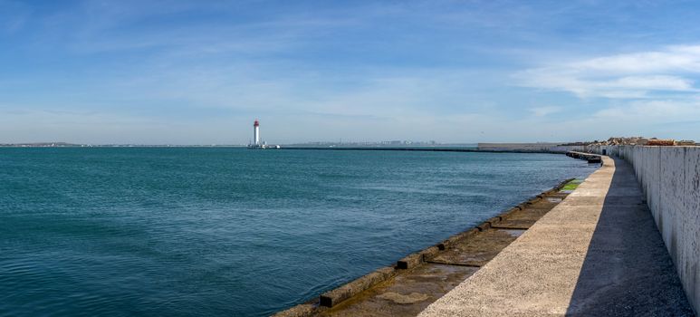 Lighthouse at the entrance to the harbor of Odessa seaport, on a sunny summer day