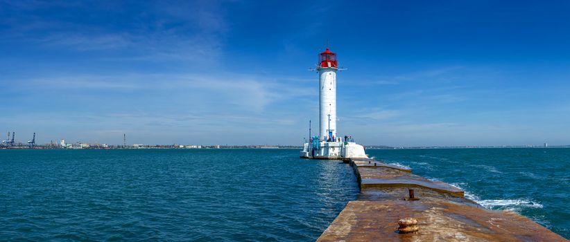 Lighthouse at the entrance to the harbor of Odessa seaport, on a sunny summer day