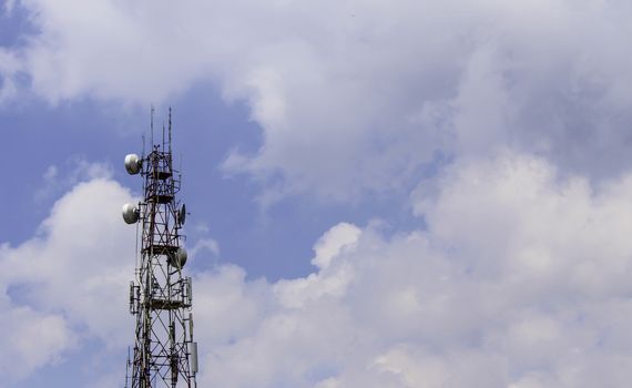 Electronic signal pole with cloud and blue sky background.