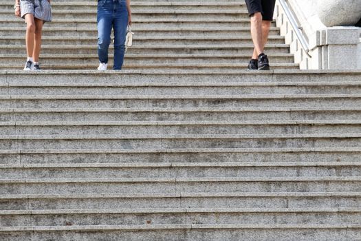 People walking down on concrete stairs in the park.