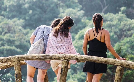 Rear view of group of friends standing together for take a photo. Friendship concept.