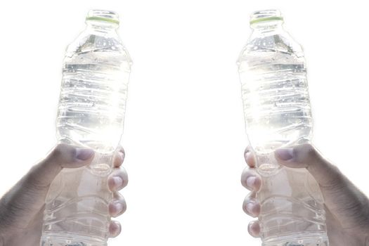 Hand holding fresh pure water bottle on white background. Selective focus and space for text.