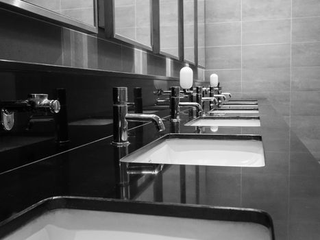 Close-up of row modern ceramic wash hand basins. Toilets in the mall at Chiang mai city.