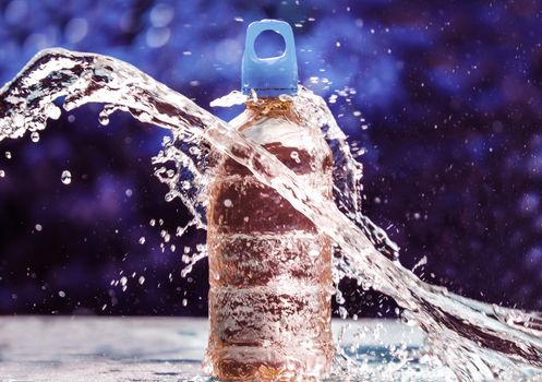 Fresh water splashing around of pure water bottle with blurred background. Selective focus and space for text.