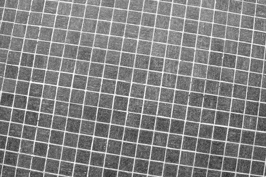 Small grey square mosaic tiles abstract background and texture.