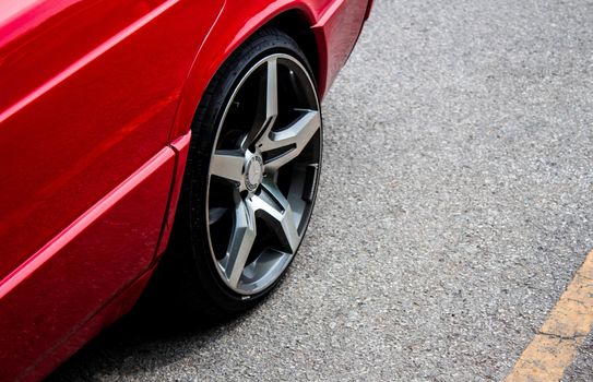 24 May 2019, The front side of a red car with modern sport wheel, parked in the parking lot at viewpoint in Inthanon peak moutain, Chiang Mai, Thailand.