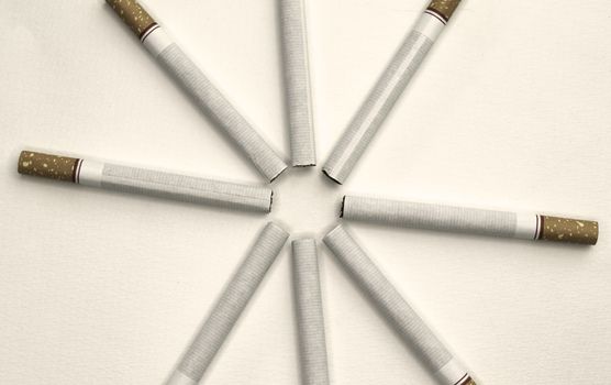 World No Tobacco Day; Sort cigarettes in a circle on grey background.