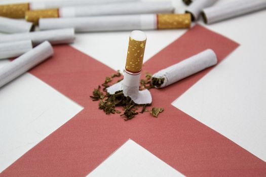 World No Tobacco Day; Broken cigarette on red cross with many Cigarettes on white background.