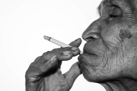 World No Tobacco Day; Elderly Asian man is smoking isolated on white background with space for idea text.