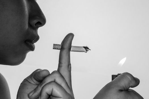 World No Tobacco Day; Asian young woman is smoking isolated on grey background with space for text.