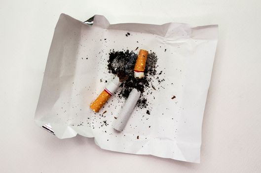 World No Tobacco Day; Cigarette with black ashes isolated on white background and space for text.