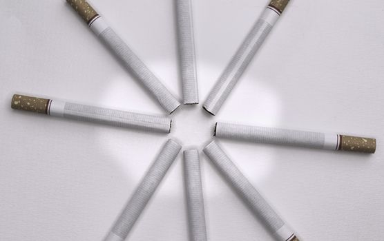 World No Tobacco Day; Sort cigarettes in a circle on grey background.