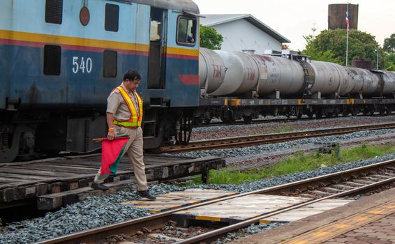 1 May 2019, Officials were holding flags and walk going to show a sign of safety into the landing zone at Lamphun station, Thailand.