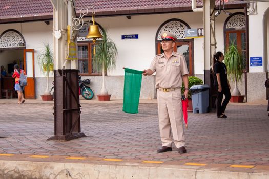 1 May 2019, Officials were waving green flags as a sign of safety while the train was running into the landing zone at Lamphun station, Thailand.